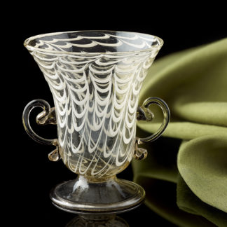 A little glass vessel with ‘ a penne ‘ decoration and applied handles