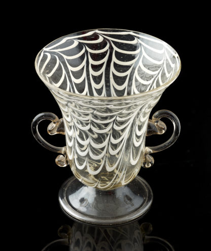 A little glass vessel with ‘ a penne ‘ decoration and applied handles