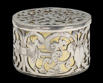 A circular strapwork Box, silver and parcel gilt, Dutch c.1660