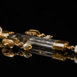 A rock crystal devotional pendant, consisting of a crucifix with gold mounts and small natural pearl drops; Italian, c.1550