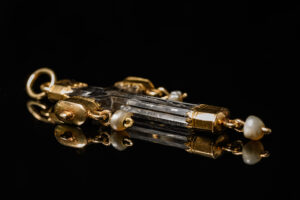 A rock crystal devotional pendant, consisting of a crucifix with gold mounts and small natural pearl drops; Italian, c.1550