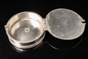 A rare silver travelling Pyx of circular form; English c.1685 back open